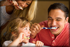 Young family brushing teeth