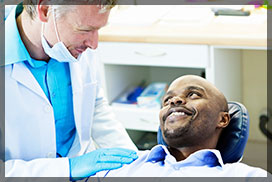 Dentist Checking a Male Patient Before Root Canal Treatment