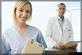 Male Dentist and Female Nurse Smiling