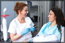 Young Female Patient and Dentist Smiling