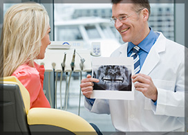 Dentist Showing Dental X Ray To a Woman Before Oral Surgery